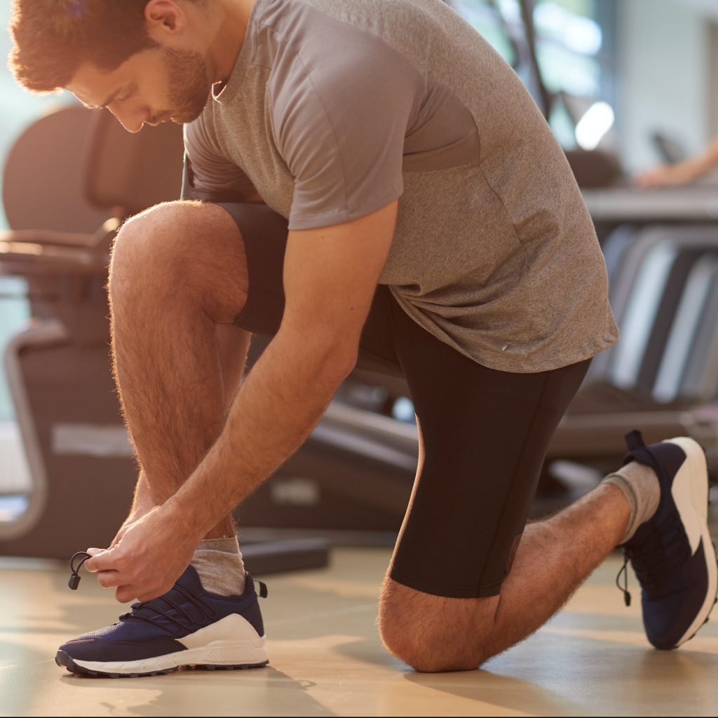 Sportive Man Tying Shoes